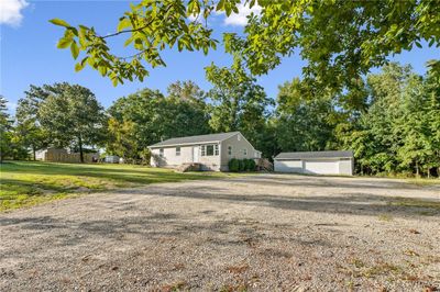 View of front of property with a garage and an outdoor structure | Image 3