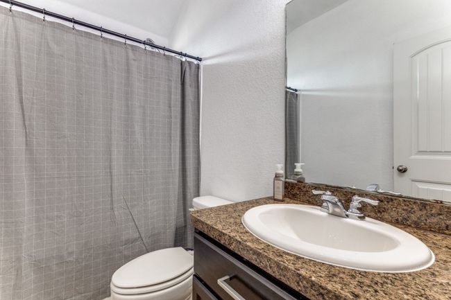 Bathroom with vanity and a shower with shower curtain | Image 29