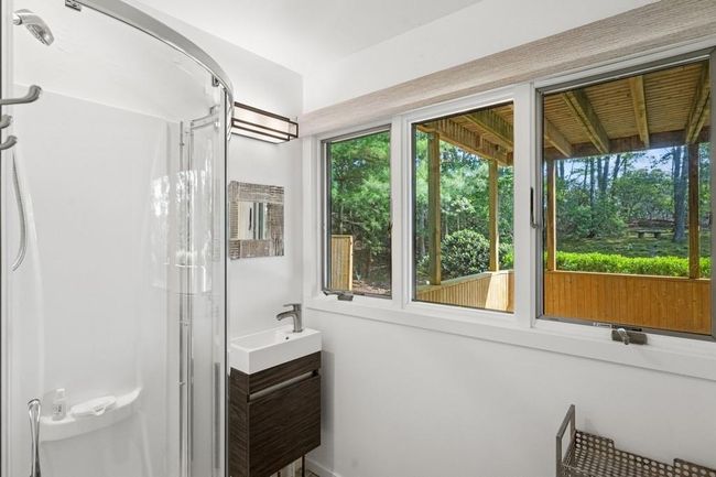 Bathroom featuring a shower stall and vanity | Image 14