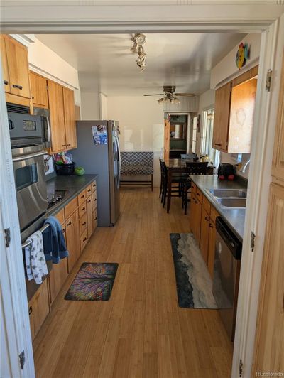 Kitchen and Breakfast Nook - Poplar Cabinets Access to Sunroom and Basement | Image 1