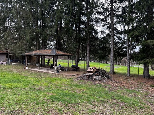 View of yard featuring a gazebo and fence | Image 17