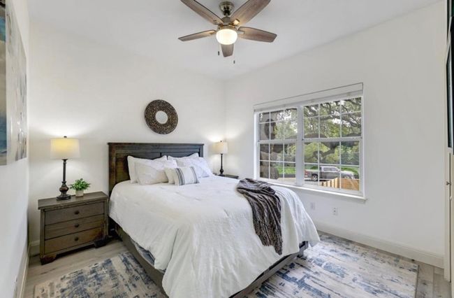 Bedroom featuring baseboards, wood finished floors, and ceiling fan | Image 23