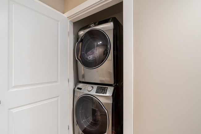 Laundry area featuring stacked washer / drying machine | Image 25