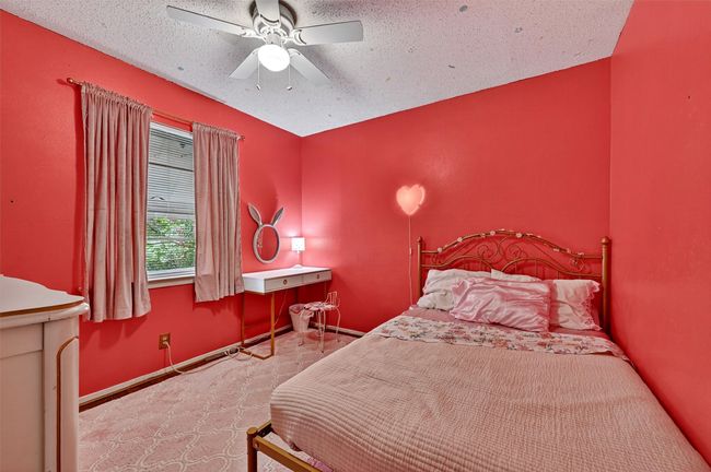 Carpeted bedroom featuring ceiling fan and a textured ceiling | Image 20
