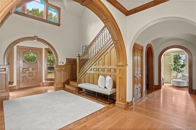 CUSTOM ENTRY // Oak front door with bolection molding, raised panels and oval glass welcomes you to water views the moment you enter. | Image 14