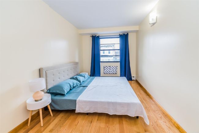 Bedroom featuring wood finished floors | Image 5