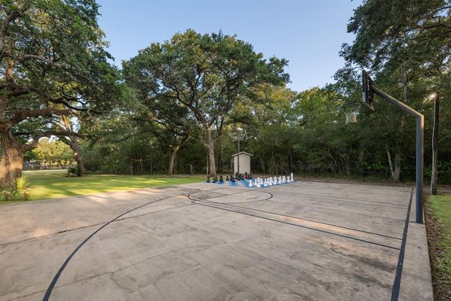 Lighted basketball court 50’ long by 37’ wide located behind the pool house.Floor is painted with basketball lines as well as squares for outdoor chess or checkers games. | Image 41