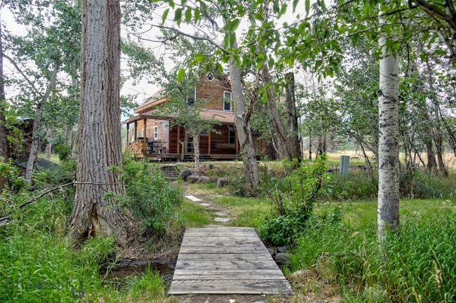 Bridge and path through the woods to Grizzly Meadows Cottage | Image 21