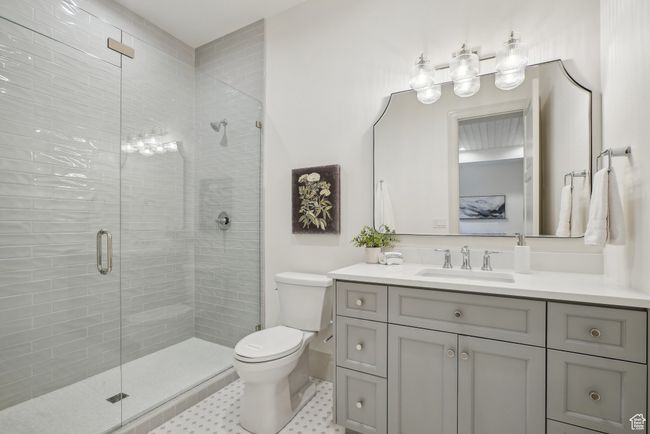 Bathroom featuring toilet, a shower stall, and vanity | Image 47