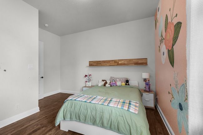 Bedroom featuring wood finished floors and baseboards | Image 30