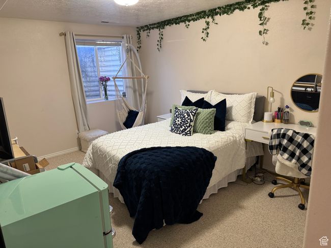 Bedroom with carpet flooring, a textured ceiling, and visible vents | Image 15