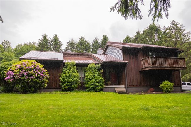 View of front of house with a front lawn, a chimney, metal roof, and a standing seam roof | Image 24