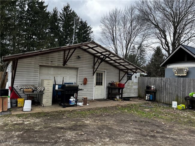 View of outbuilding featuring an outbuilding, fence, and dirt driveway | Image 5