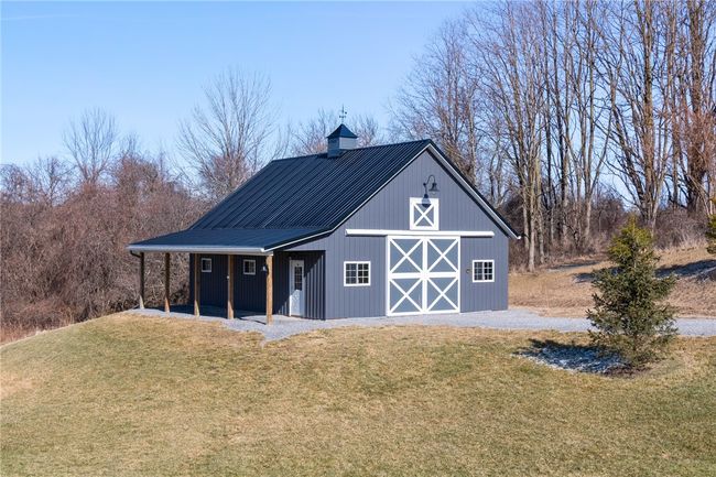 The pole barn - great concrete area and also has plenty of storage on the second floor! Even has a stall inside! | Image 5