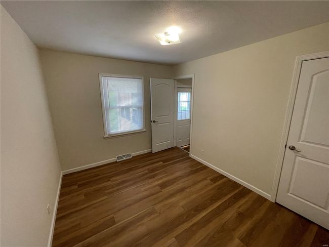 Unfurnished room with baseboards, dark wood-type flooring, and visible vents | Image 30