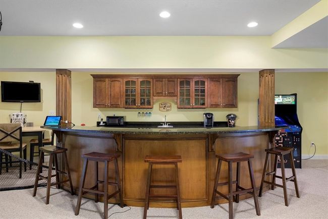 Custom bar with dishwasher and sink is ideal for entertaining guests! | Image 35