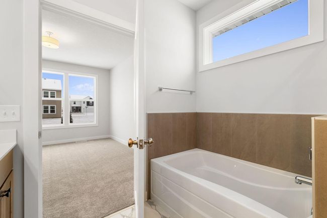 The master bathroom offers a spa-like escape, featuring a spacious soaker tub that invites relaxation and tranquility. Elegant finishes and a serene atmosphere make it the perfect place to unwind. | Image 24