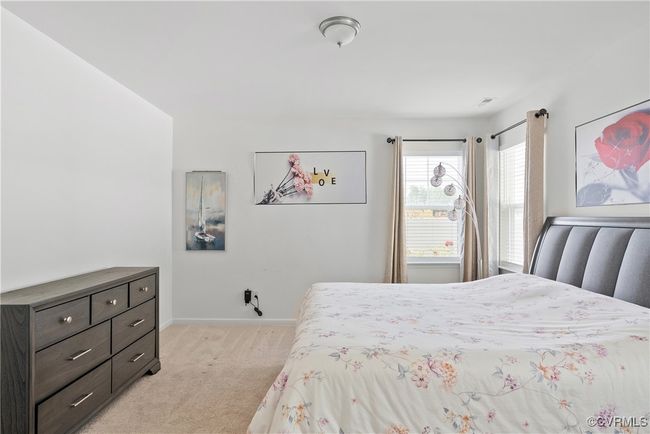 Bedroom featuring light colored carpet and baseboards | Image 17