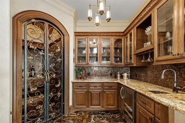 Wet bar and wine room are right off the formal living room | Image 15