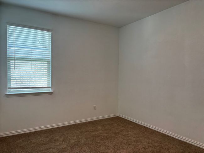 Spare room featuring dark colored carpet and baseboards | Image 13