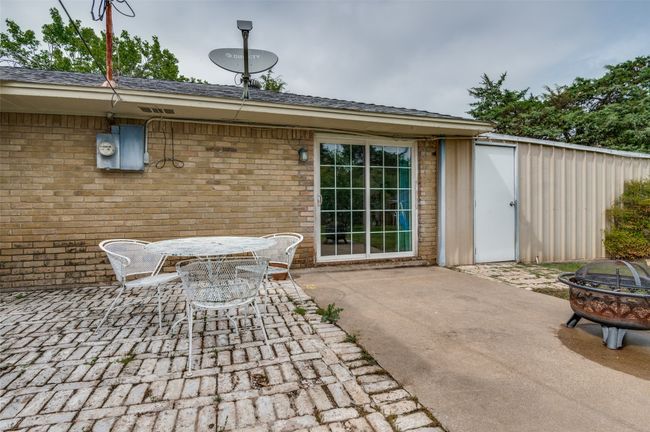 View of patio featuring an outdoor fire pit and outdoor dining space | Image 22