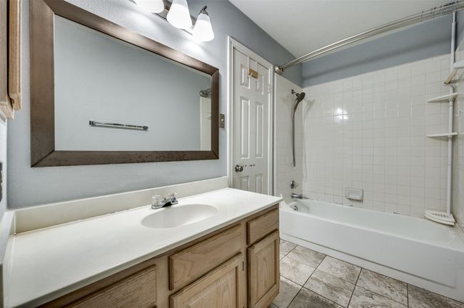 Bathroom with shower / tub combination, vanity, and tile patterned floors | Image 17