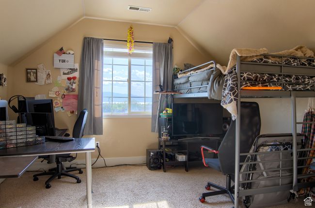 Carpeted bedroom with vaulted ceiling, visible vents, and baseboards | Image 16