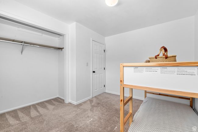 Bedroom with carpet flooring and baseboards | Image 13