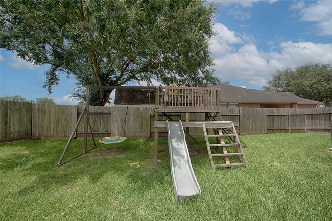 Backyard includes a playground for the kids which will stay with the property for the lucky new owner. | Image 34