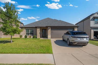 View of front of home featuring a garage and a front lawn | Image 1