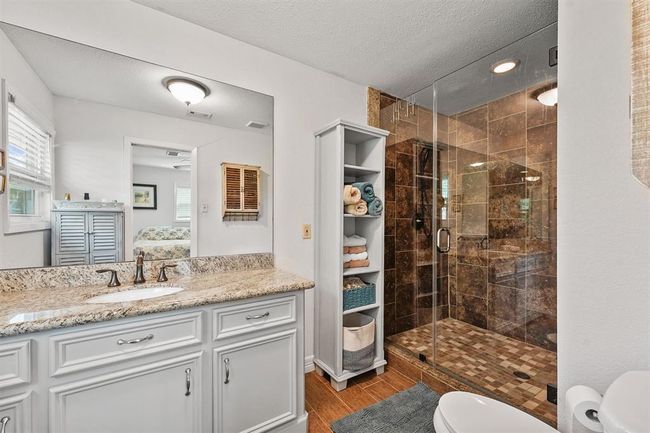 Stylish en-suite bathroom featuring a spacious walk-in shower, updated finishes for a clean, contemporary feel. | Image 12
