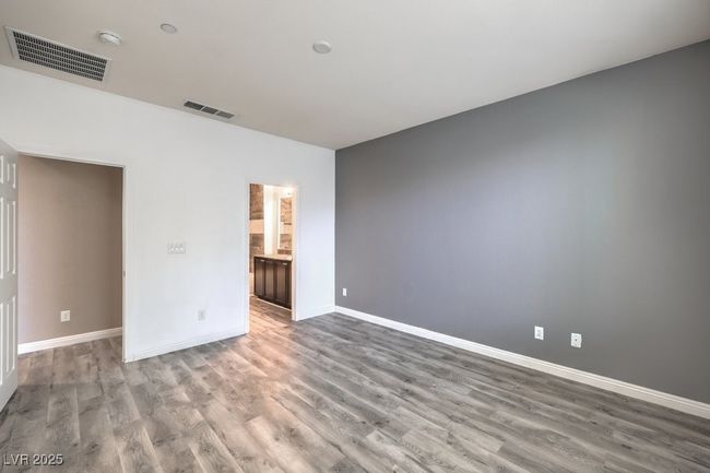 Empty room with baseboards, visible vents, and wood finished floors | Image 9