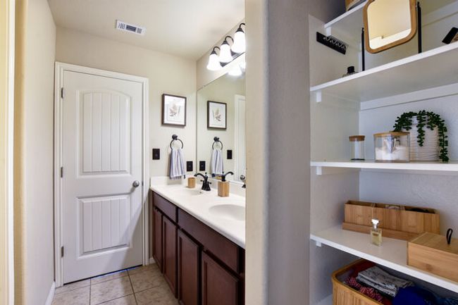 Jack and Jill bath with shelving and room for a hamper!! | Image 24
