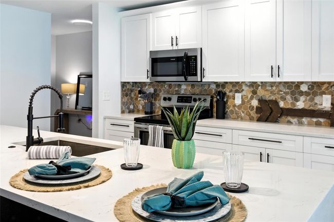 The island accommodates multiple barstools—ideal for everyday dining, morning coffee, or keeping the one cooking company! | Image 21