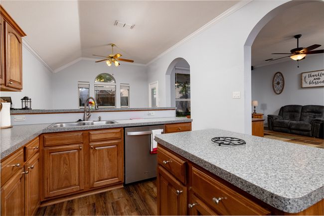 Kitchen with visible vents, a ceiling fan, stainless steel dishwasher, and dark wood-style​​‌​​​​‌​​‌‌​‌‌​​​‌‌​​‌‌​‌​​​​​‌ floors | Image 22