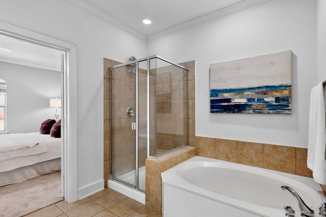 Ensuite bathroom with crown molding, a bath, a stall shower, tile patterned flooring, and recessed lighting | Image 25