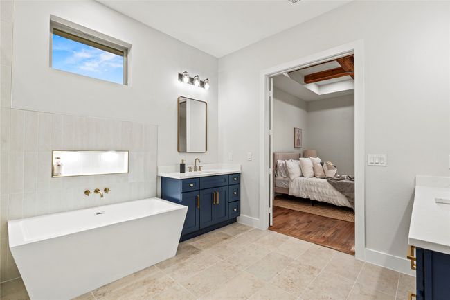 Full bathroom featuring vanity, a freestanding tub, and connected bathroom | Image 16