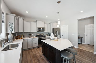 (*Photo of decorated model, actual homes colors and finishes will vary) Open and naturally bright, the home's kitchen space is highly desirable | Image 2