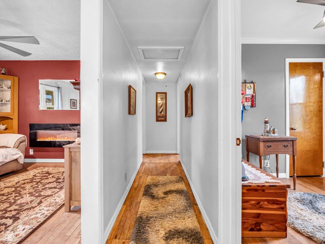 hall featuring attic access and wood-type flooring | Image 22