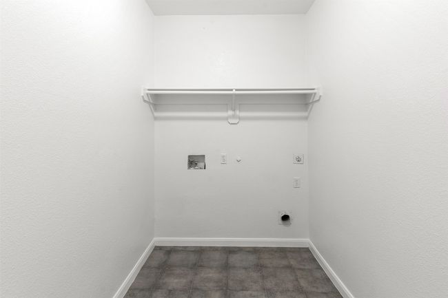 Laundry room featuring hookup for a gas dryer, hookup for an electric dryer, laundry area, baseboards, and hookup for a washing machine | Image 24