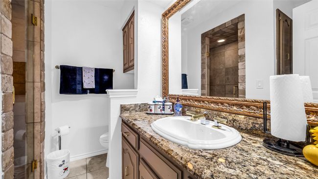 Full bathroom with vanity, a shower stall, and tile patterned flooring | Image 17