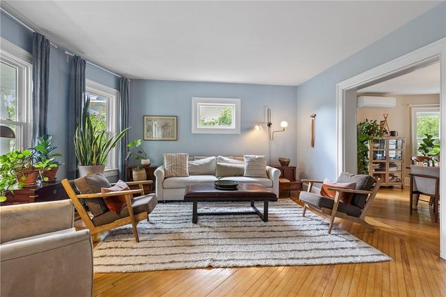 Off of the foyer you can enter the sun filled living room | Image 7
