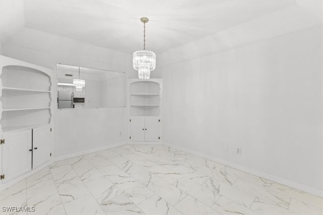 Unfurnished room with light tile patterned flooring and a chandelier | Image 22