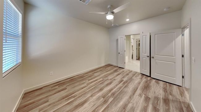 Unfurnished bedroom with baseboards, recessed lighting, multiple windows, and light wood-style flooring | Image 10
