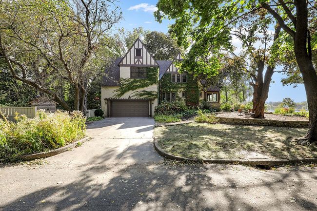 Side entry, oversized garage offers a wall of workbenches and storage, as well as an oversized storage loft for seasonal items. 220 circuit in the garage could be converted to e-vehicle charger, or power workshop. | Image 28