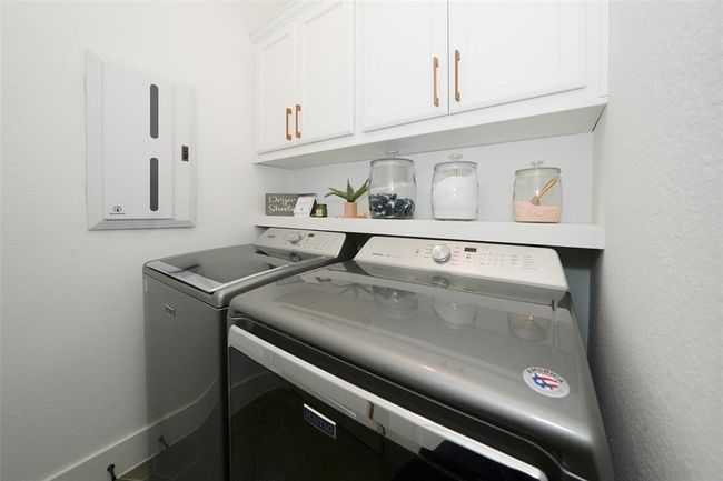 Efficient utility room featuring modern appliances and ample storage space. | Image 33