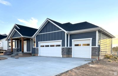 View of front of home with covered porch and a garage | Image 2