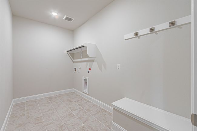 Laundry room featuring hookup for a gas dryer, hookup for a washing machine, electric dryer hookup, and recessed lighting | Image 10