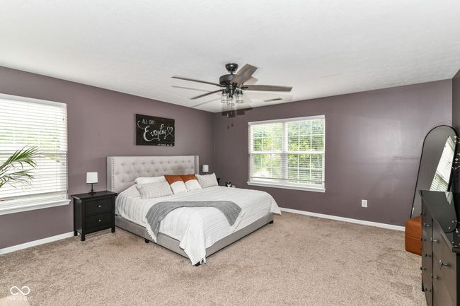 bedroom featuring baseboards, light carpet, and ceiling fan | Image 14