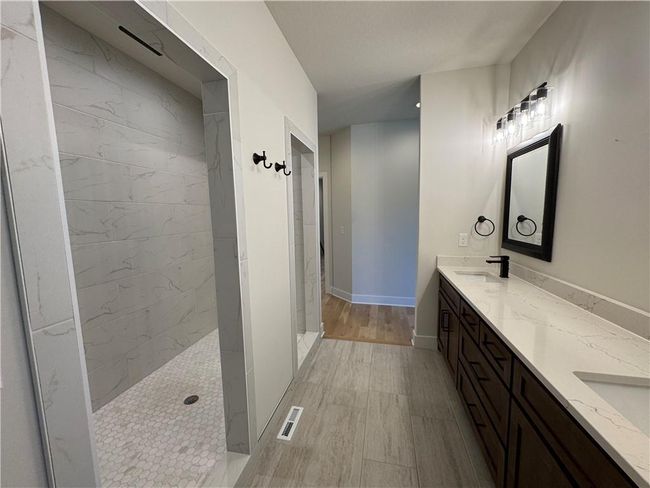 Full bath featuring double vanity and a walk in shower | Image 28